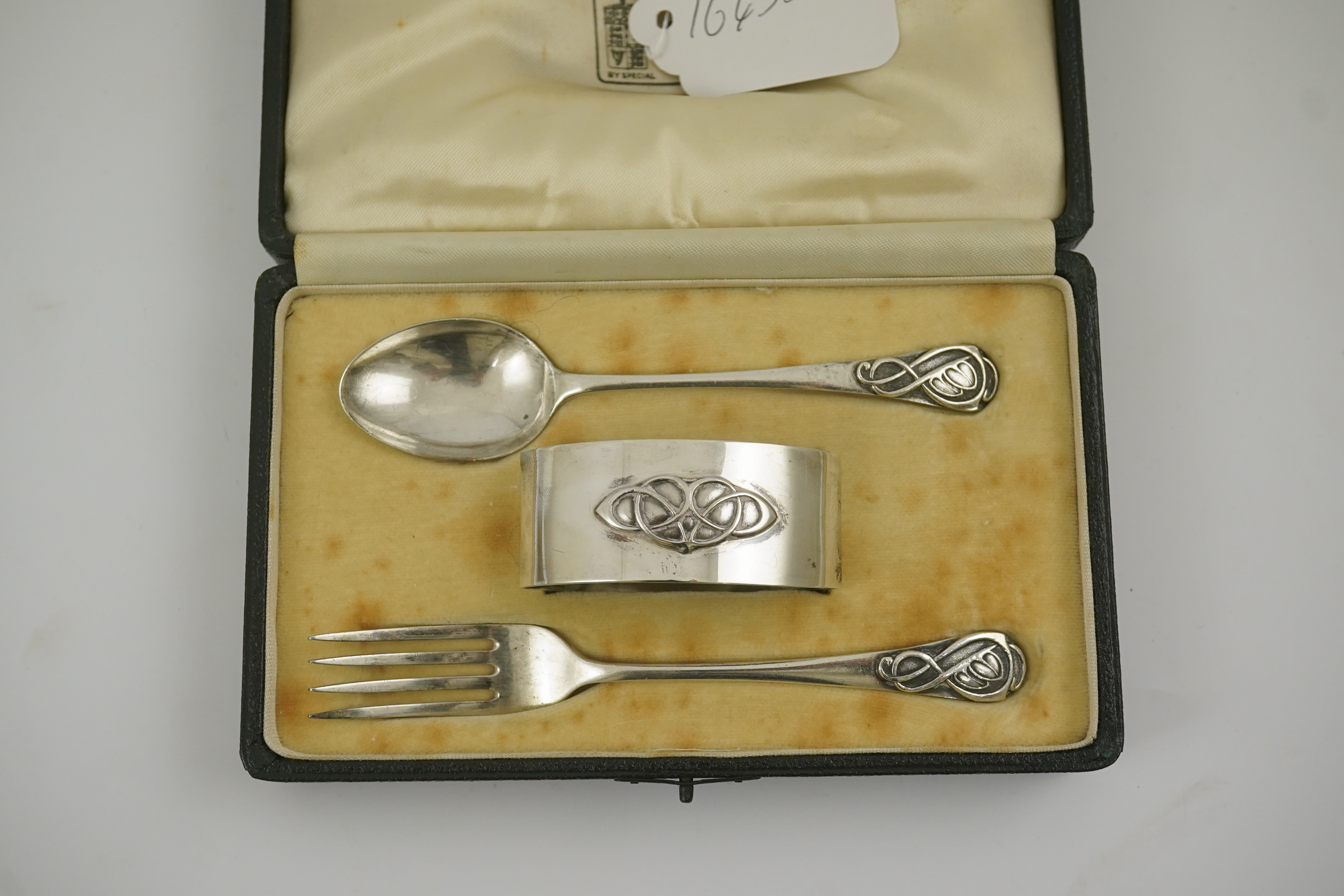 A 1930's Arts & Crafts Liberty & Co cased silver three piece christening set